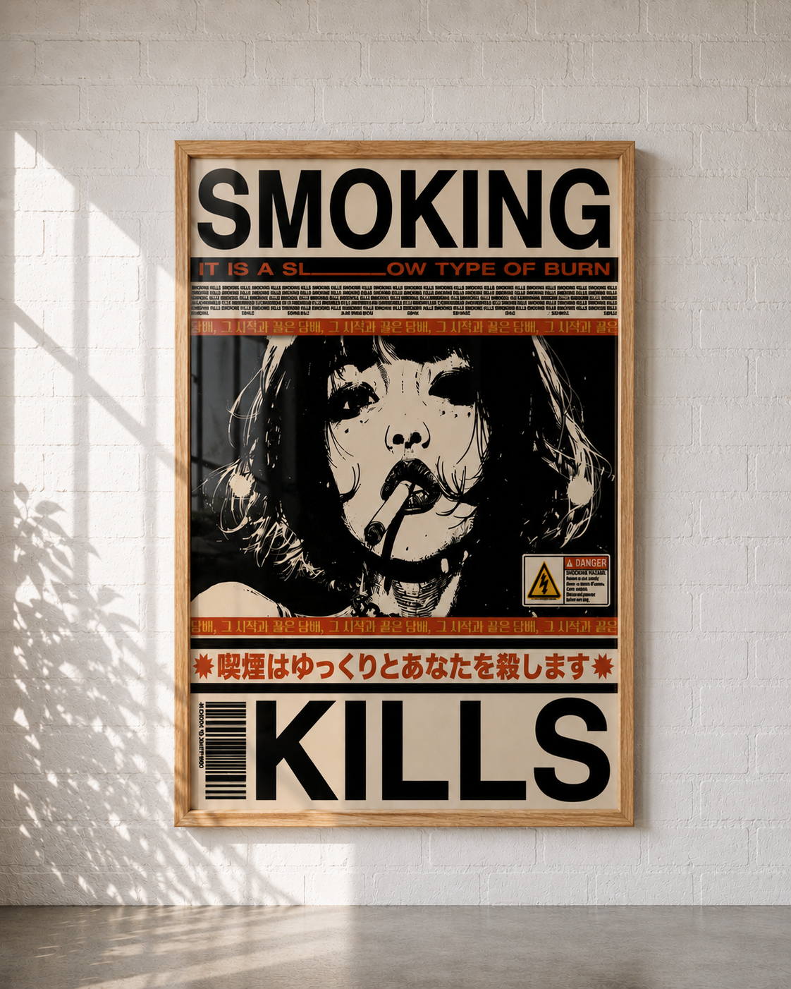 A framed poster with a black, white, and orange warning-style design reading 'SMOKING' and 'KILLS,' displayed against a white brick wall with soft window shadows.